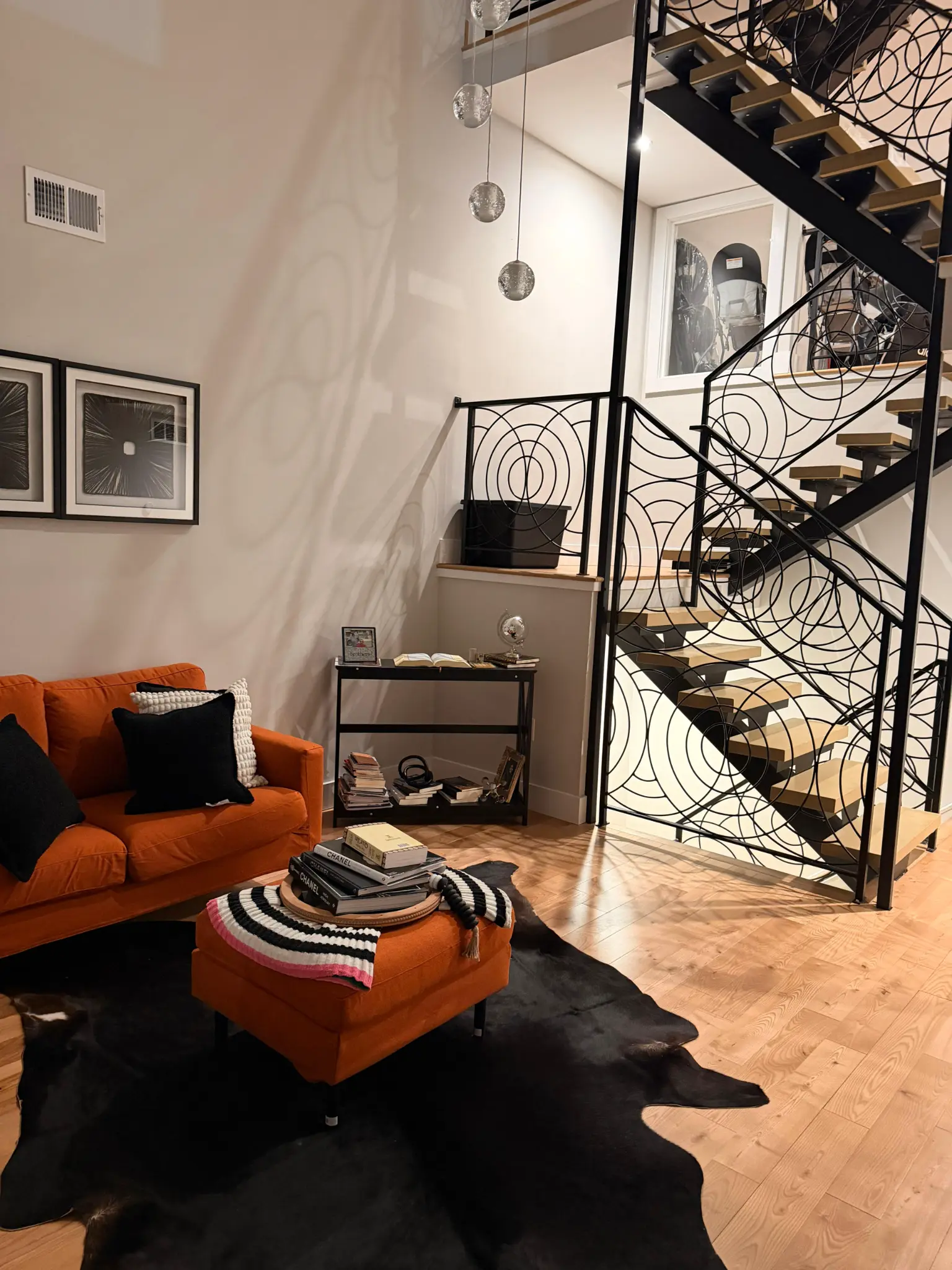 Artistic living room with custom staircase and clean floors