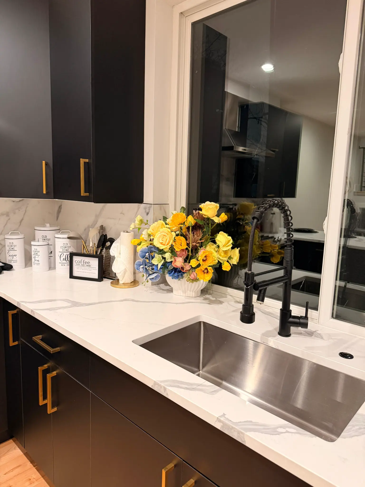Kitchen with marble countertop and beautiful flower arrangement