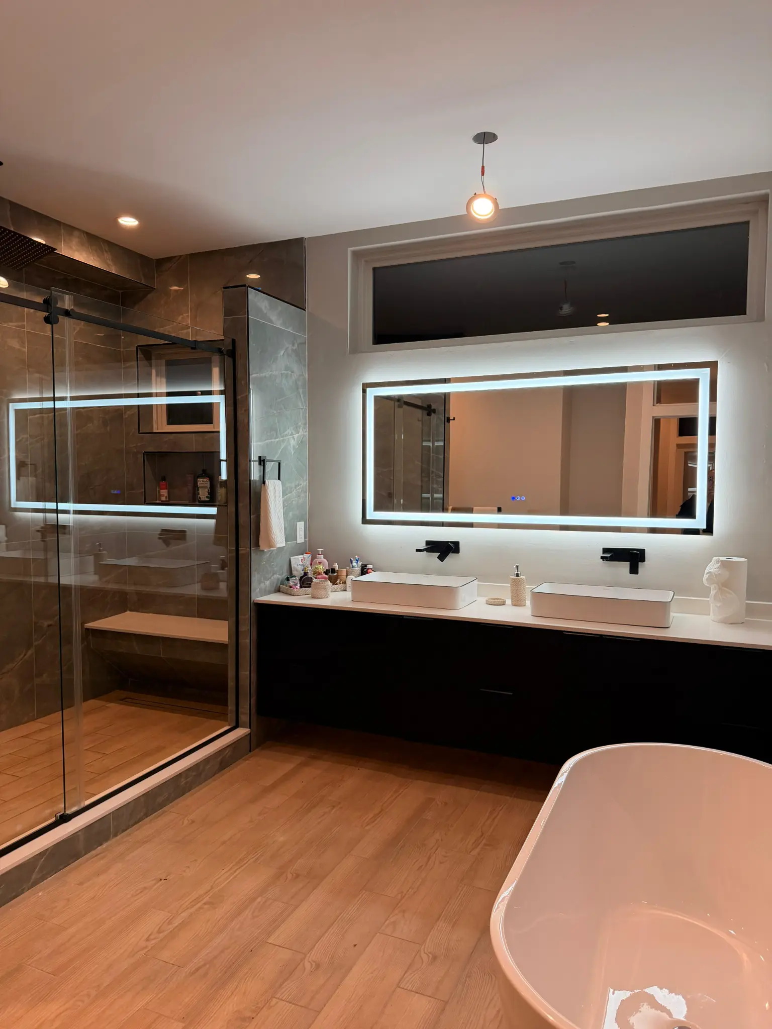 Master bathroom with LED mirror and freestanding tub