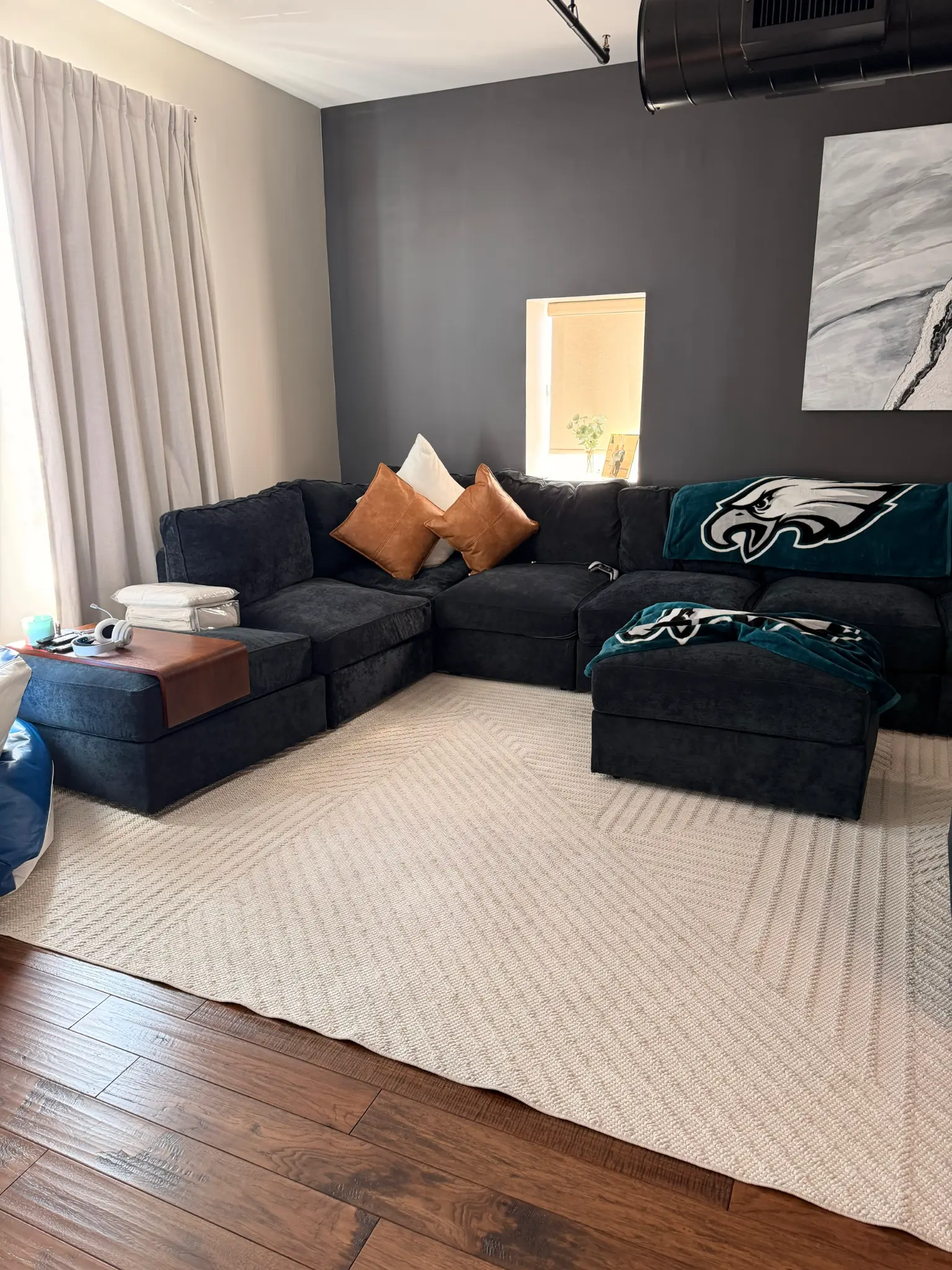 Clean living room with sectional sofa and area rug